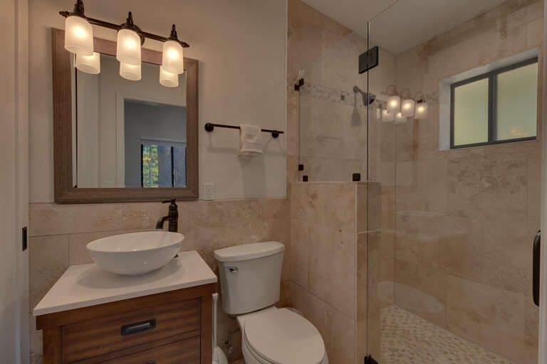 Bathroom with glass enclosed shower Bathroom with glass enclosed shower