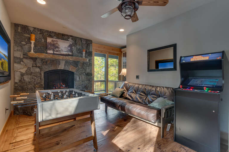 Recreation area with foosball, arcade, flat screen tv, and comfy couch