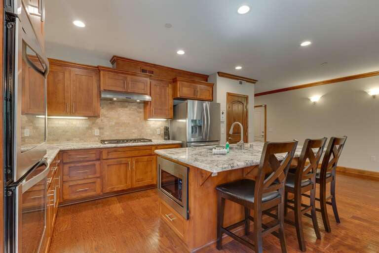 Kitchen with stainless-steel appliances, and spacious island