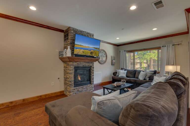 Living area with comfy sectional sofa, flat screen tv, and fireplace