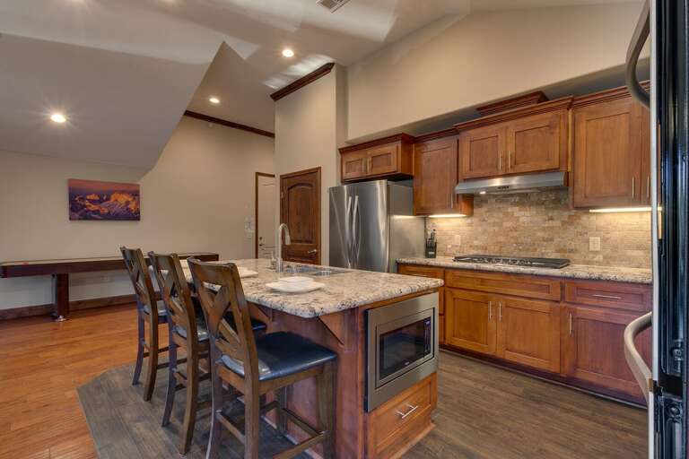 Kitchen area with stainless-steel appliances, and spacious island