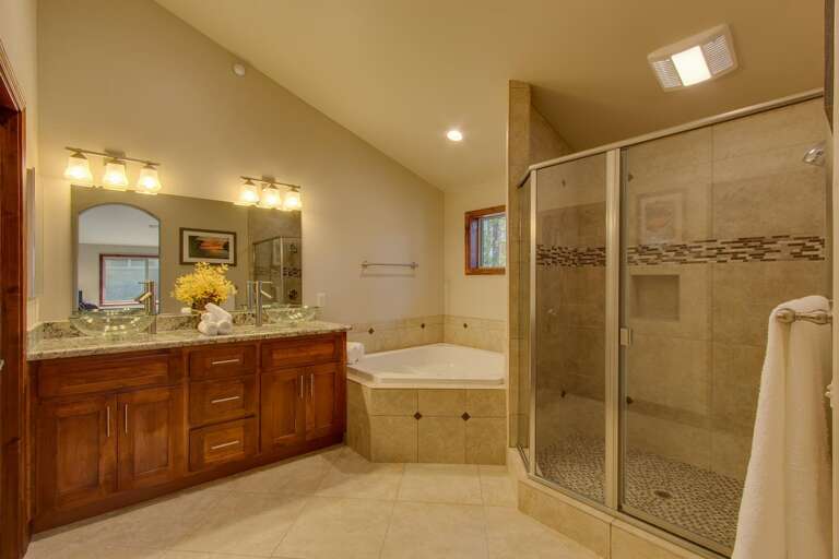 Bathroom with dual sinks, jetted tub, and glass enclosed shower Bathroom with dual sinks, jetted tub, and glass enclosed shower