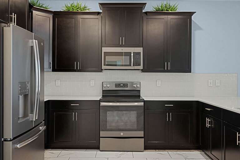 Kitchen area with stainless-steel appliances Kitchen area with stainless-steel appliances