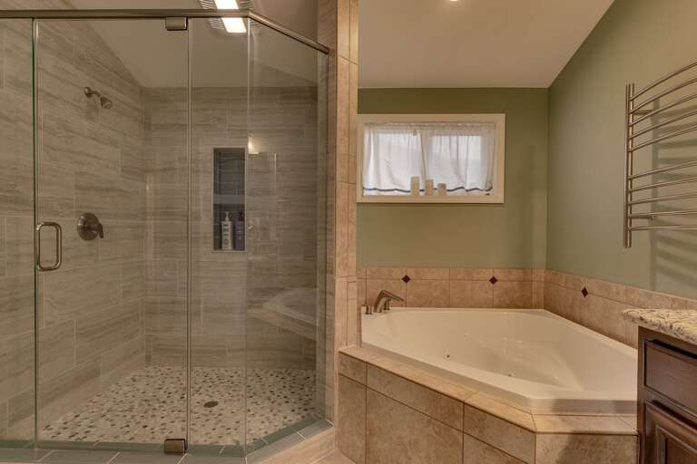 Bathroom with jetted tub and glass-enclosed shower