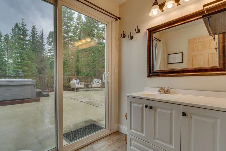 Bathroom with access to deck with hot tub and seating area
