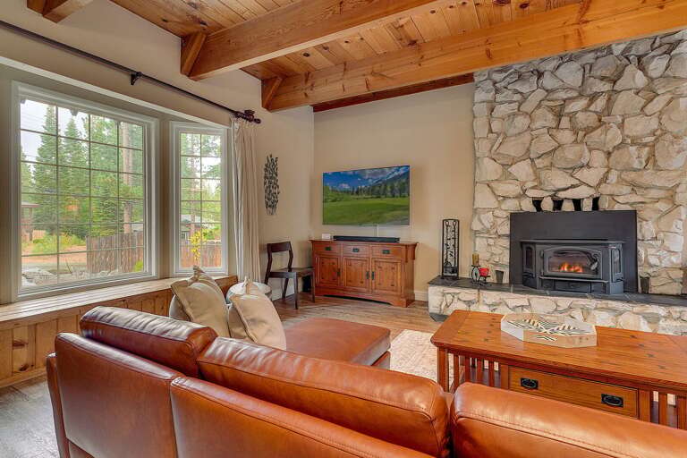 Living area with comfy couch, flat screen TV. and fireplace