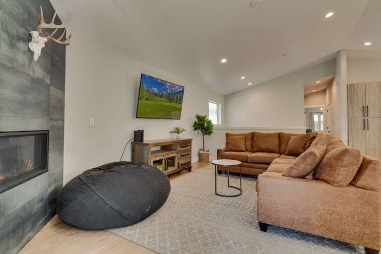 Living area with comfy couch, flat screen TV, and fireplace