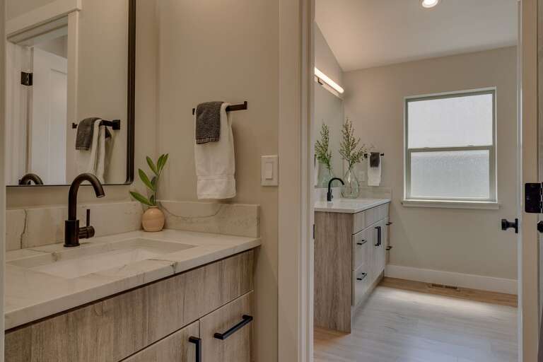 Bedroom w/ Dual Sinks, Soaker Tub, and Shower