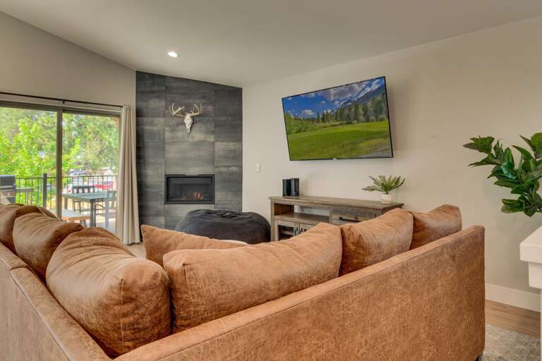 Living area with comfy couch, flat screen TV, and fireplace Living area with comfy couch, flat screen TV, and fireplace