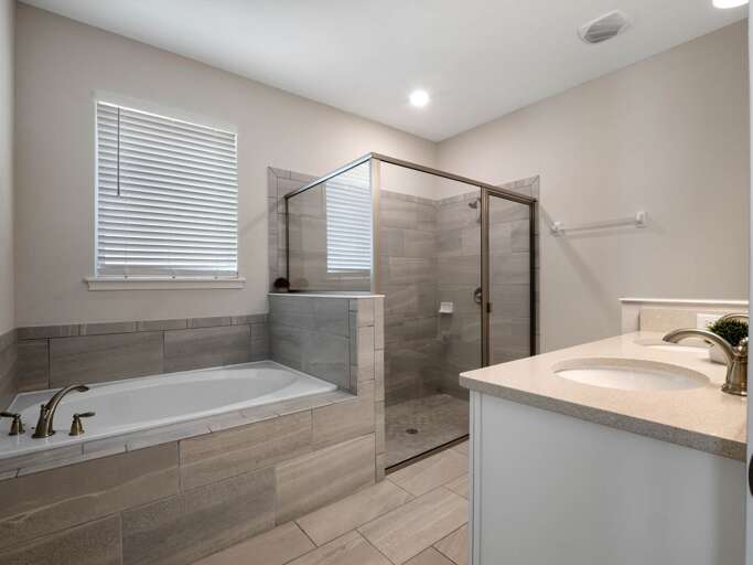 Bathroom with dual sinks, glass enclosed shower, and large soaker tub Bathroom with dual sinks, glass enclosed shower, and large soaker tub