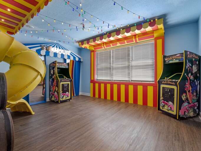 Toy story themed game room with kid's slide, arcades, and funhouse mirrors Toy story themed game room with kid's slide, arcades, and funhouse mirrors