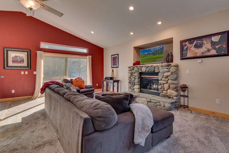 2nd level living area with comfy couch, fireplace, and flat screen TV