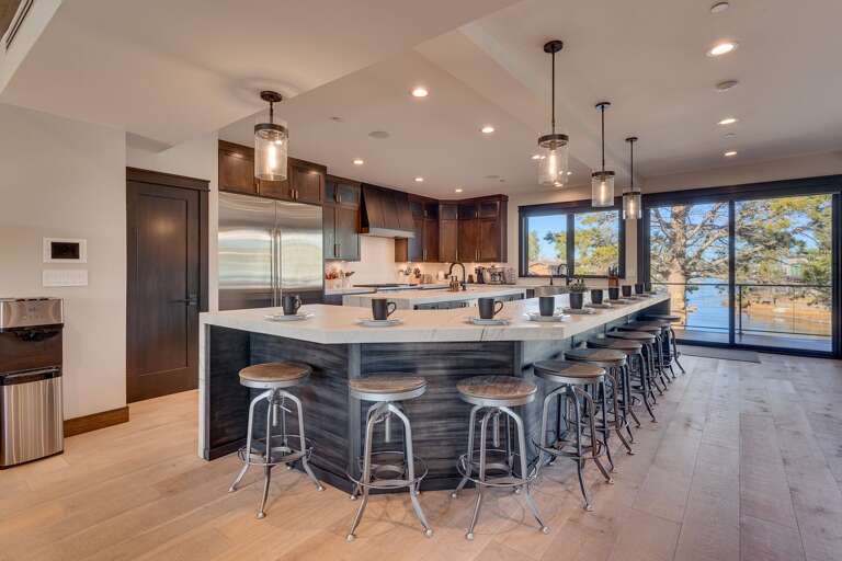 Elegant kitchen with stainless steel appliances, large island, and panoramic views