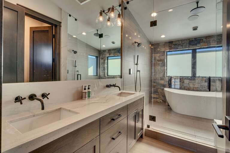 Spa like bathroom with dual sinks and soaker tub