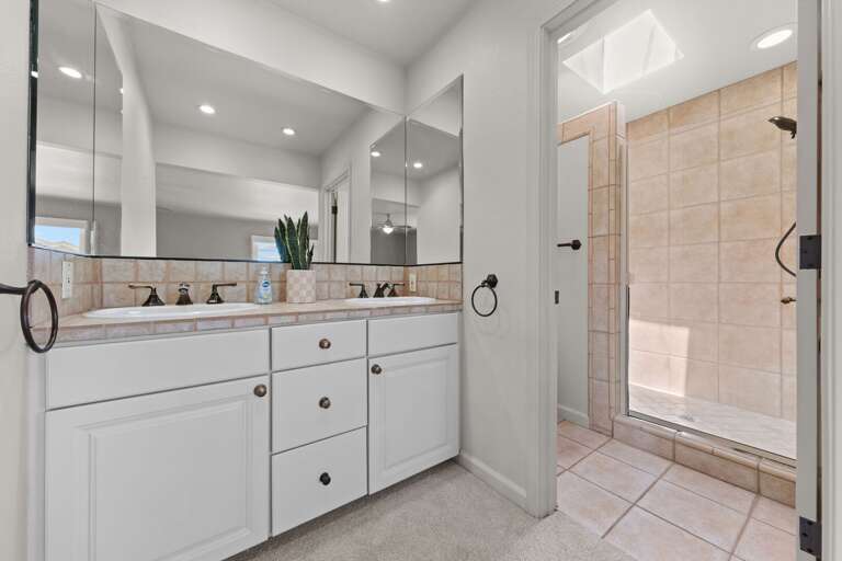 Dual sink bathroom with glass enclosed shower Dual sink bathroom with glass enclosed shower