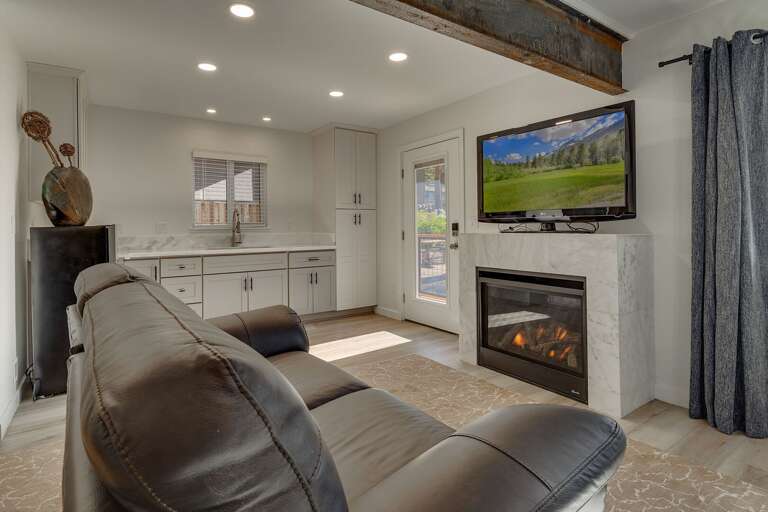 TV, fireplace, and comfy couch in bedroom
