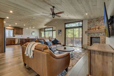 Living area w/ comfy couch, flat screen TV, and fireplace