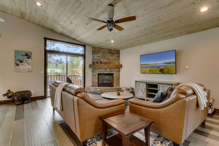 Living area w/ comfy couch, flat screen TV, and fireplace