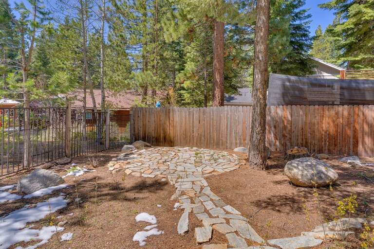 - Backyard area with stone patio feature
- Private outdoor space shaded by mature trees
- Tahoe cabin atmosphere with natural surroundings