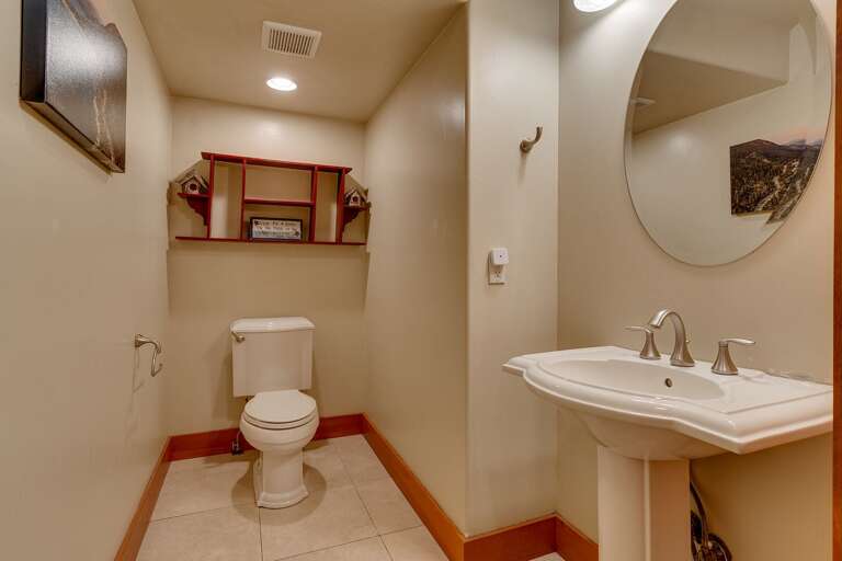 - Convenient entry-level half bathroom
- Easy access powder room for guests and common areas
- Clean and functional guest restroom on the main level