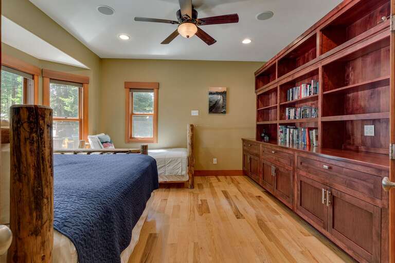 - Custom built-in shelving with plenty of storage space
- Spacious layout with comfortable sleeping arrangements
- Warm wood finishes and inviting cabin-style design