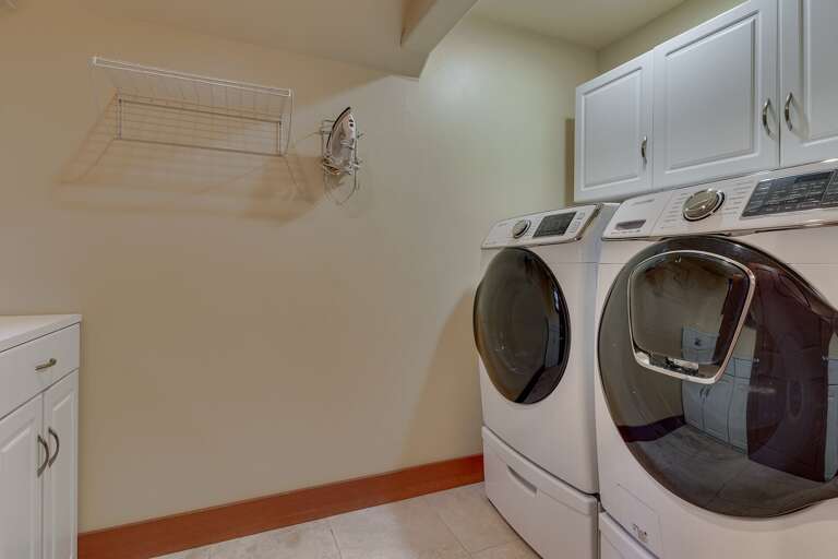 - Dedicated upstairs laundry area with washer and dryer
- Convenient in-home laundry for extended stays
- Spacious laundry room with added storage space