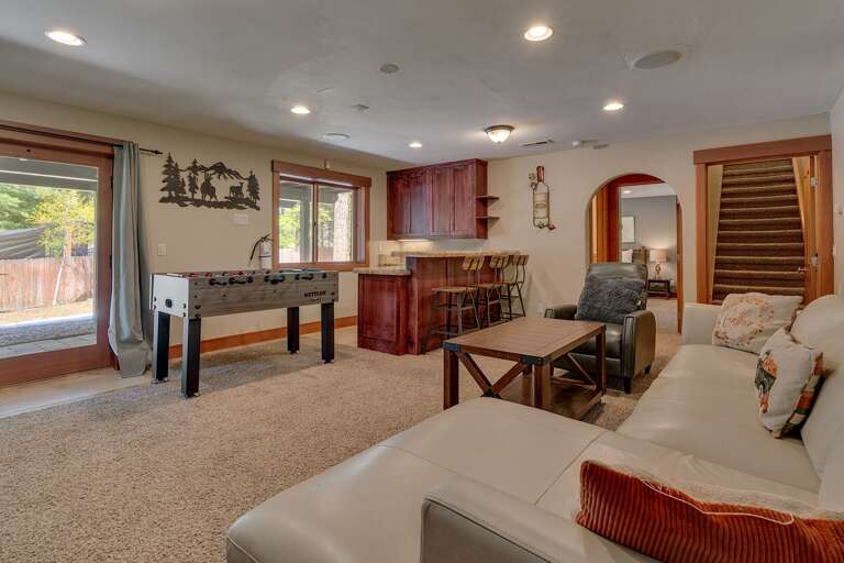 - Downstairs family room with cozy lounge seating
- Foosball table and wet bar for entertaining
- Tahoe retreat designed for movie nights and game days