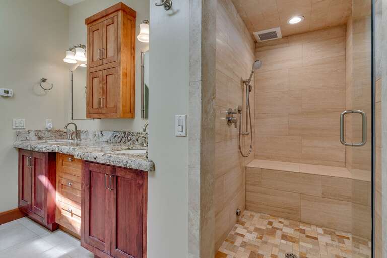 - Ensuite bathroom with dual vanity and granite countertops
- Walk-in shower with modern tile finishes and bench seating
- Tahoe retreat with a spa-inspired master bath suite