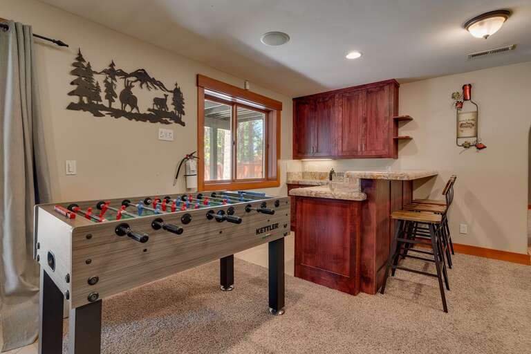 - Game area with foosball table and bar seating
- Relaxing hangout space with outdoor access
- Tahoe vacation rental perfect for group gatherings