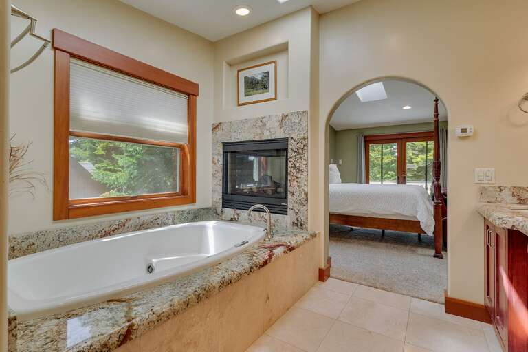 - Spa-style ensuite bathroom with soaking tub and fireplace
- Granite finishes and natural light throughout the bath
- Tahoe retreat with a relaxing primary suite bathroom
