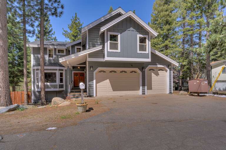 - Welcoming Tahoe exterior with ample parking
- Contemporary mountain design surrounded by trees
- Convenient access for your Tahoe getaway