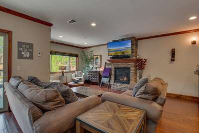 Living Area w/ Large Sectional Sofa, Flat-Screen TV, and Stone Fireplace