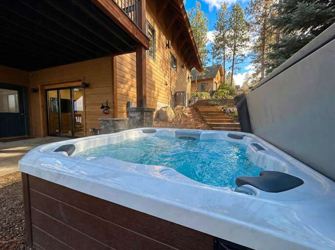Bubbling Backyard Bath By Brown Building, Beneath Blue Sky