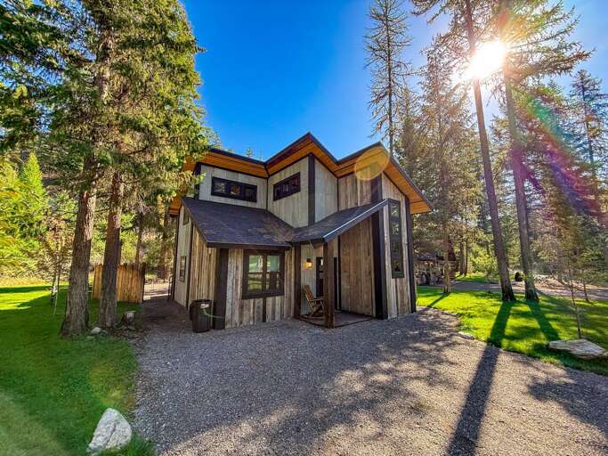 Sunlit Structure Surrounded By Slender Trees