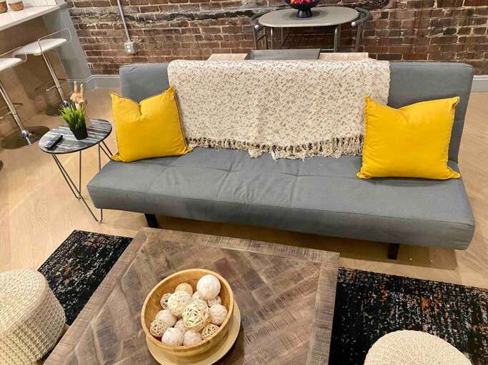 Cozy Living Room With A Gray Sofa And Yellow Cushions
