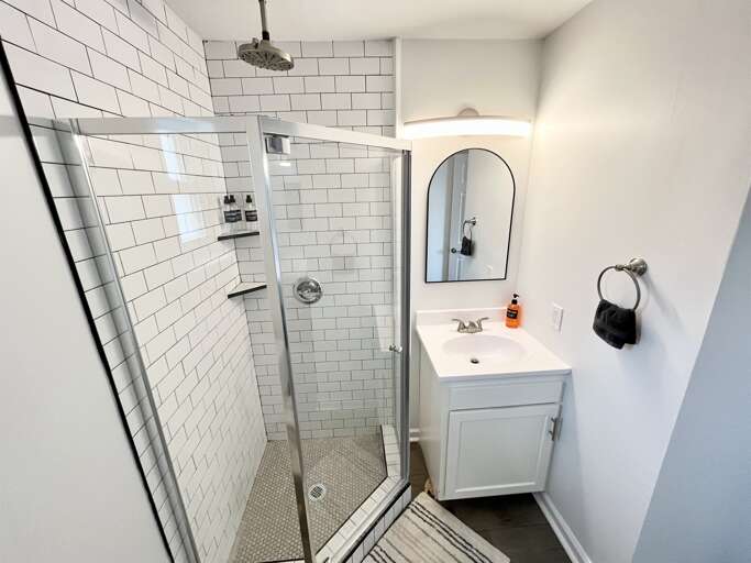 Large walk in shower with shampoo, conditioner, and body wash