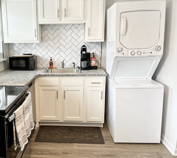 Modern Kitchen Interior With White Appliances And Cabinets