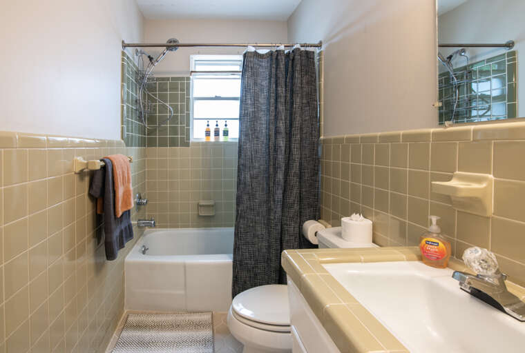 Bathroom two has a shower tub combo with a detachable shower head