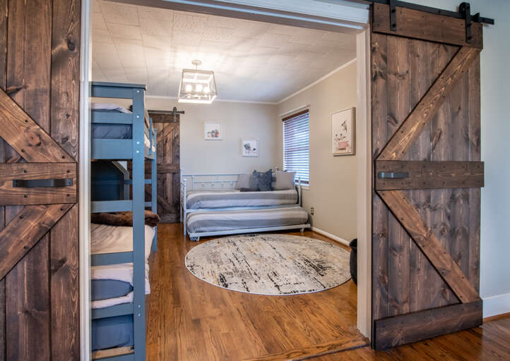 Large area rug, bean bag, and tons of kid approves sleeping spaces