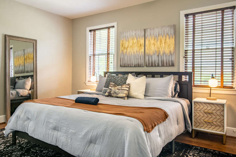 Bedroom 2 also has a king bed and a full length mirror