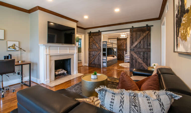 Beautiful large barn doors separate the living room and kids room.