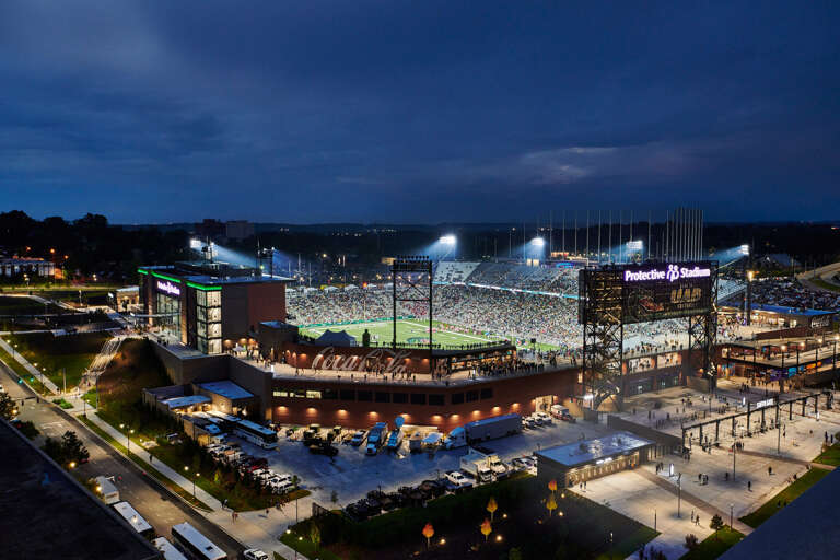 Nighttime View Of A Crowded Stadium With Illuminated Field And Surrounding Area