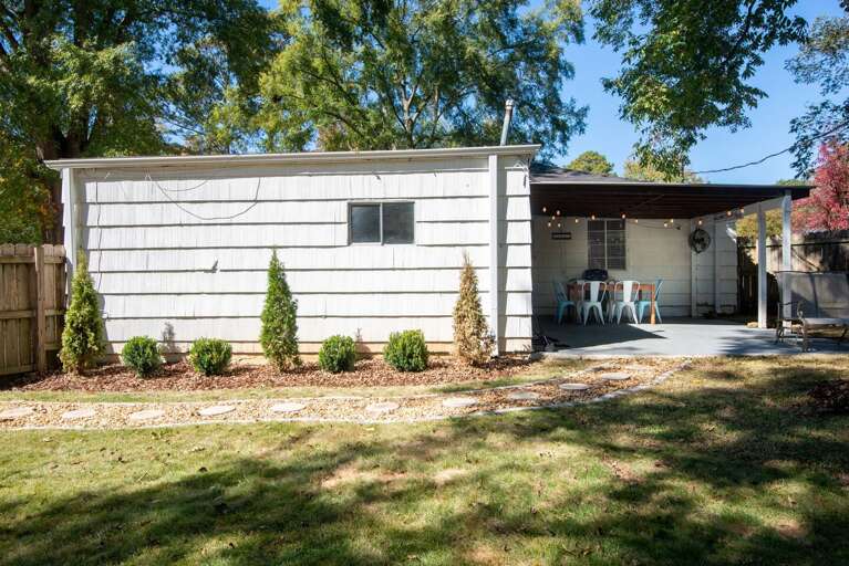 Gorgeous backyard with outdoor eating space and cafe lighting 