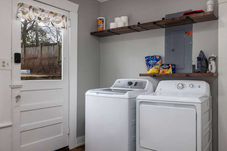 Laundry room with detergent, iron, and steamer Laundry room with detergent, iron, and steamer
