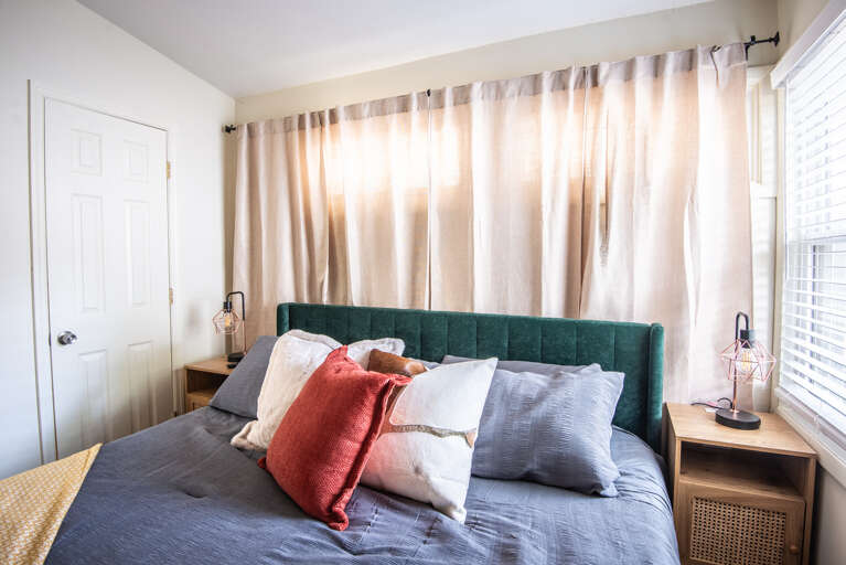 Discover comfort and style in our king bedroom. Rest easy in the spacious king-size bed, ensuring a peaceful night's sleep. Thoughtfully designed with your comfort in mind, plus a TV to catch up on all of your favorite shows. Discover comfort and style in our king bedroom. Rest easy in the spacious king-size bed, ensuring a peaceful night's sleep. Thoughtfully designed with your comfort in mind, plus a TV to catch up on all of your favorite shows.