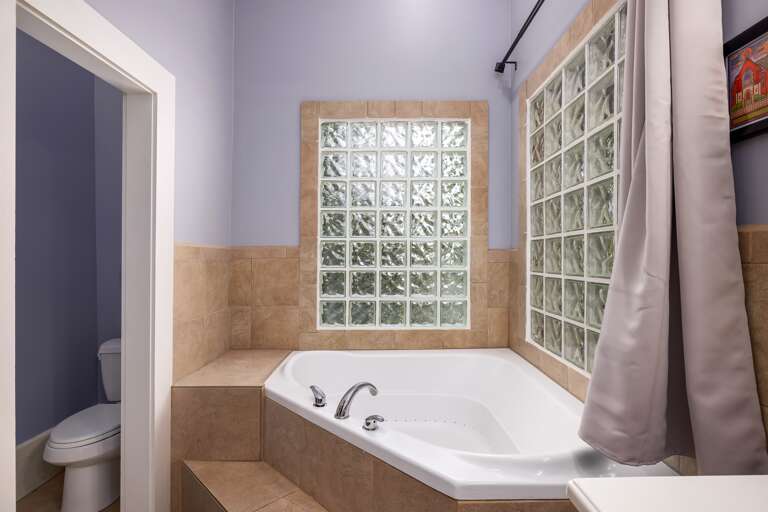 Enjoy ultimate relaxation in the large soaking tub, providing the perfect oasis to unwind and rejuvenate after a long day.