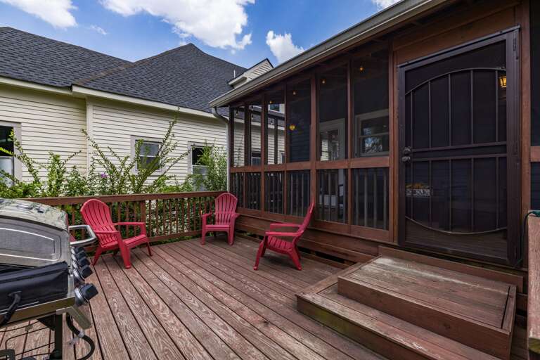 Charming back patio attached to large screened in porch, equipped with gas grill and tons of seating options.