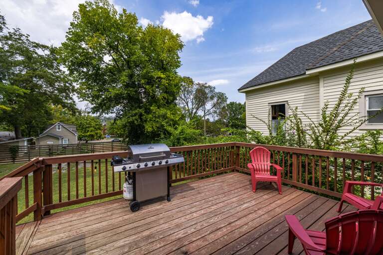 Savor outdoor gatherings on the inviting patio, equipped with a convenient gas grill and Adirondack chairs, creating the ideal setting for delicious BBQs and relaxation.