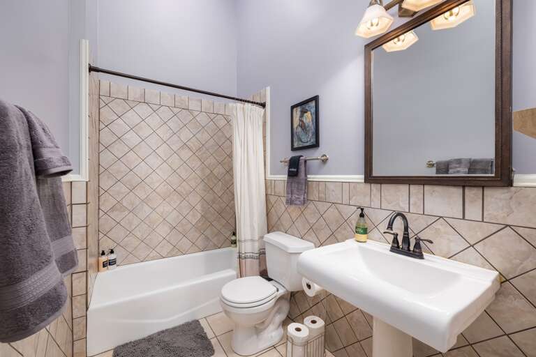 Conveniently located in the hallway, the second bathroom ensures easy access for all guests, making it a practical and essential space during your stay.