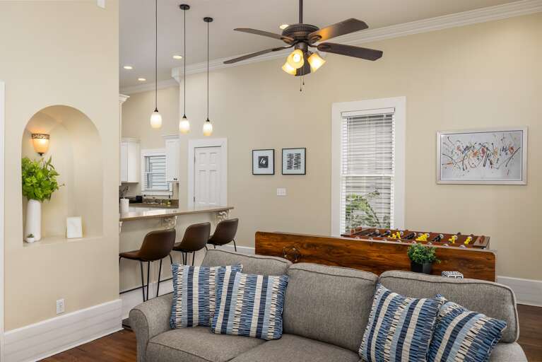 The family room, where memories are made and laughter echoes. This versatile space seamlessly blends dining and entertainment, with a dining area perfect for shared meals and a foosball table for some friendly competition. Gather, dine, and play together.